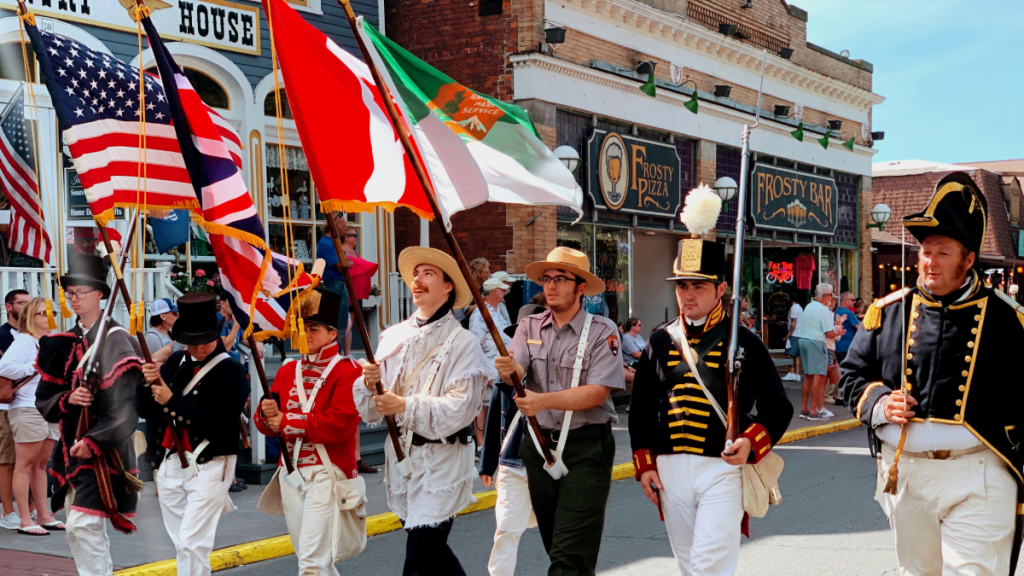 Reenactors carrying historic flags during the Historic Weekend parade on Delaware Avenue in Put-in-Bay.